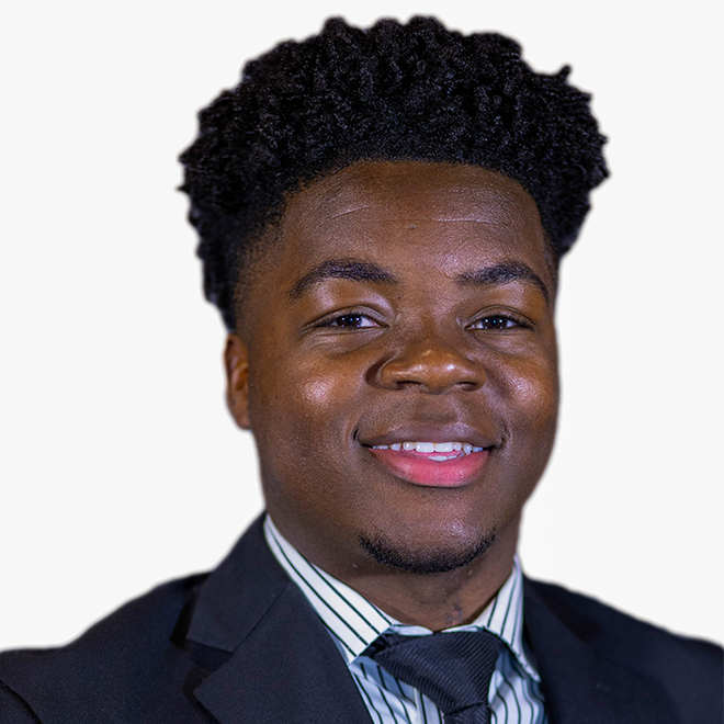 A man smiling wearing a tie