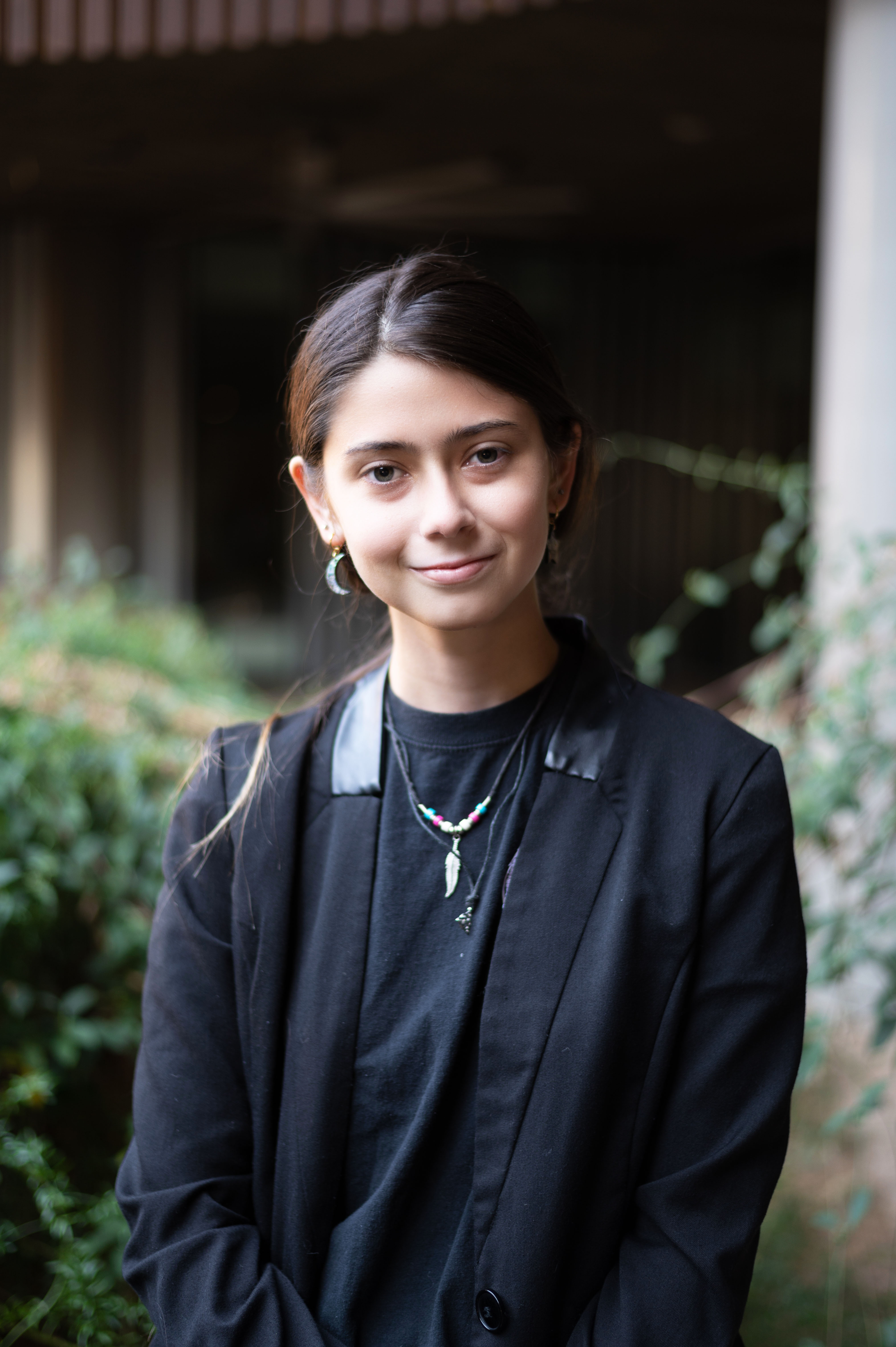 A person smiling outside wearing a jacket