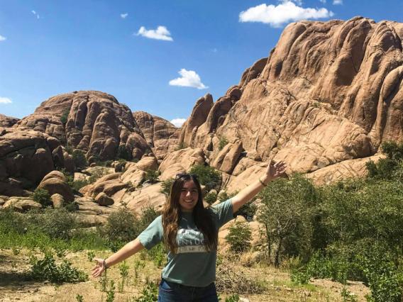Giselle Lugo in front of large rock formation