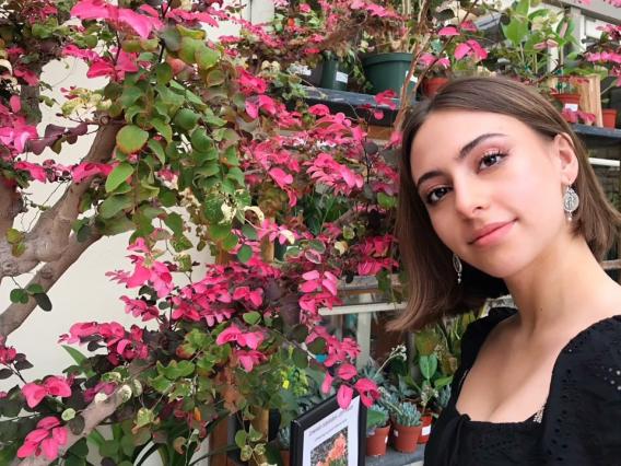 Sam Wetherell standing in front of a blooming tree