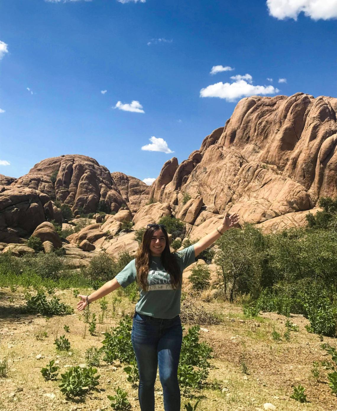 Giselle Lugo in front of large rock formation