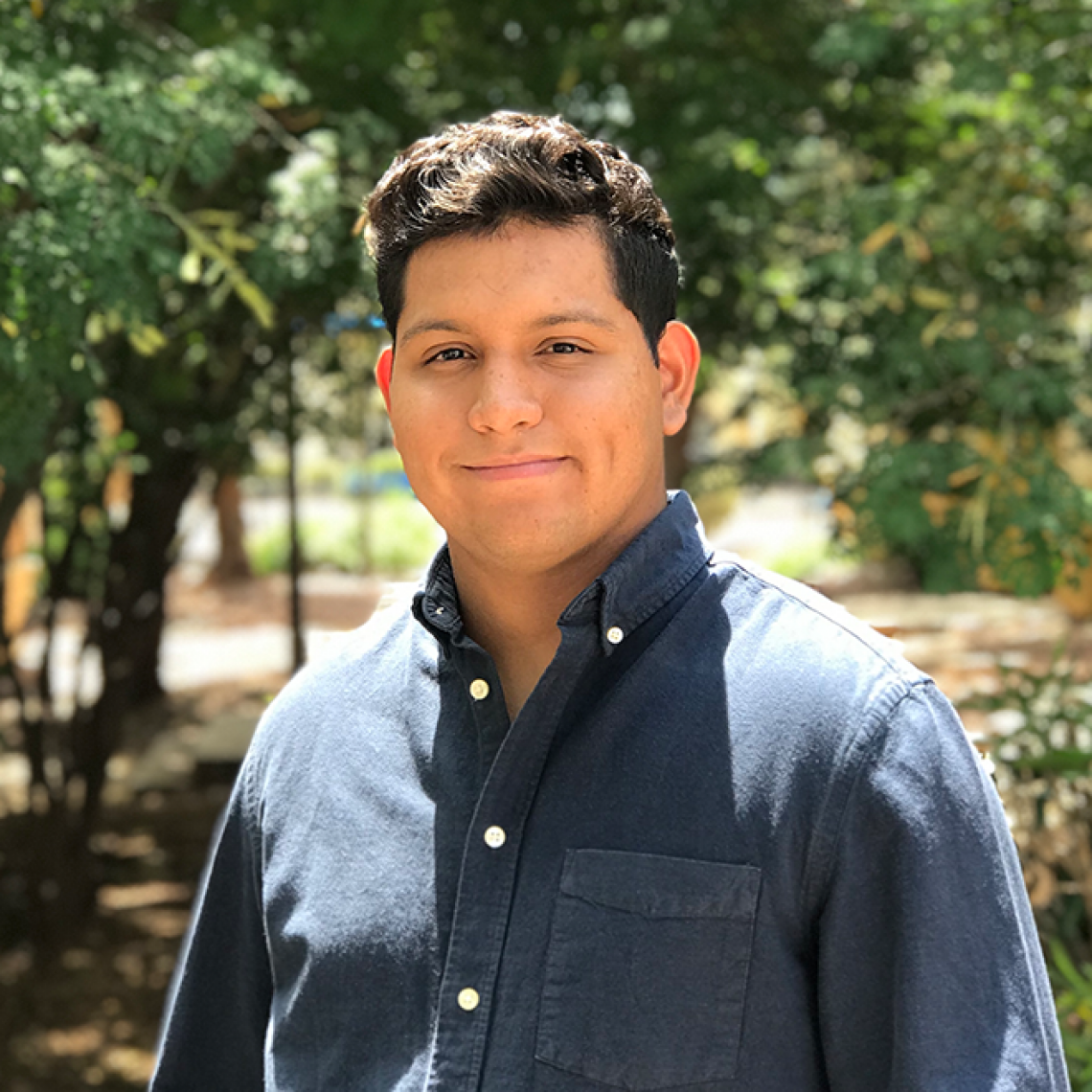 A man in a blue shirt outside