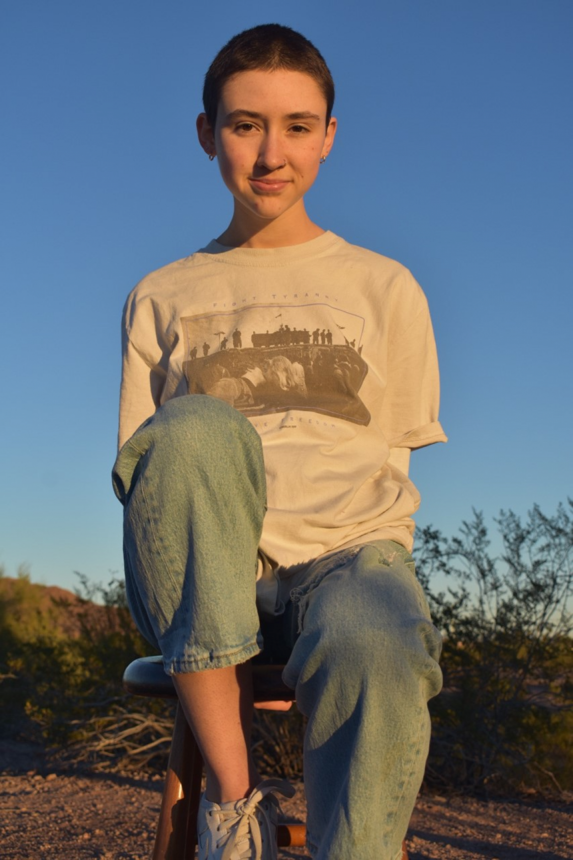 Kara Asher sitting on a rock with no arms