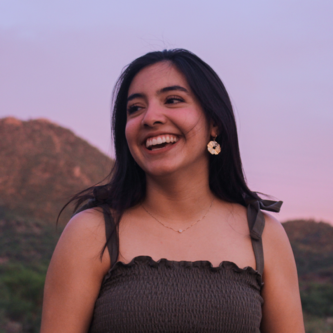 A woman smiling in a sunset