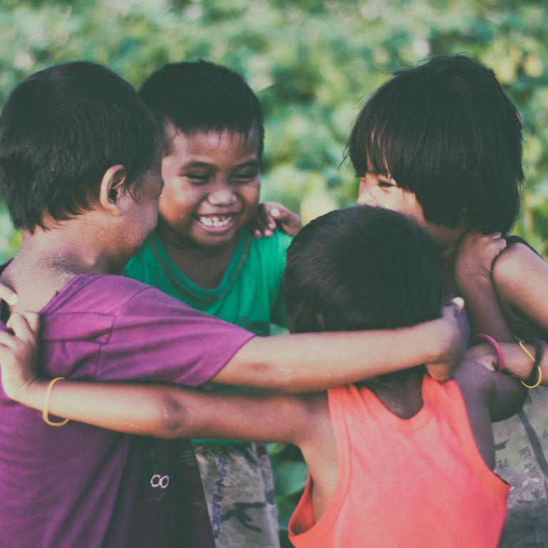 Children smiling in a circle