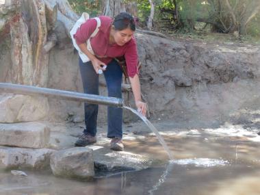 Marquel Begay collecting a water sample