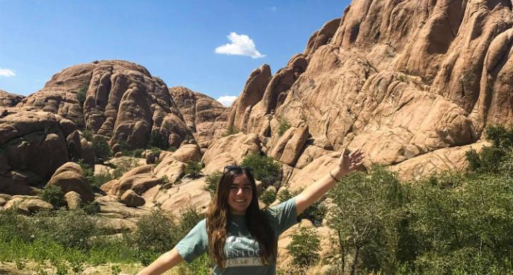 Giselle Lugo in front of large rock formation