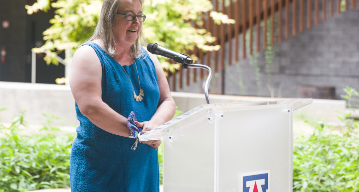 Diana Liverman speaking at podium in ENR2 building