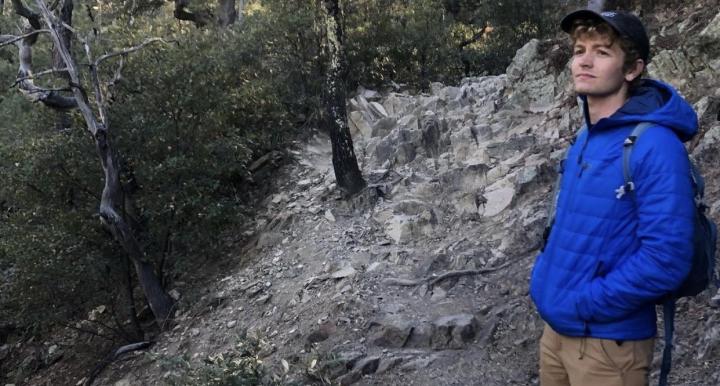 Nico Matthews standing on a shaded trail