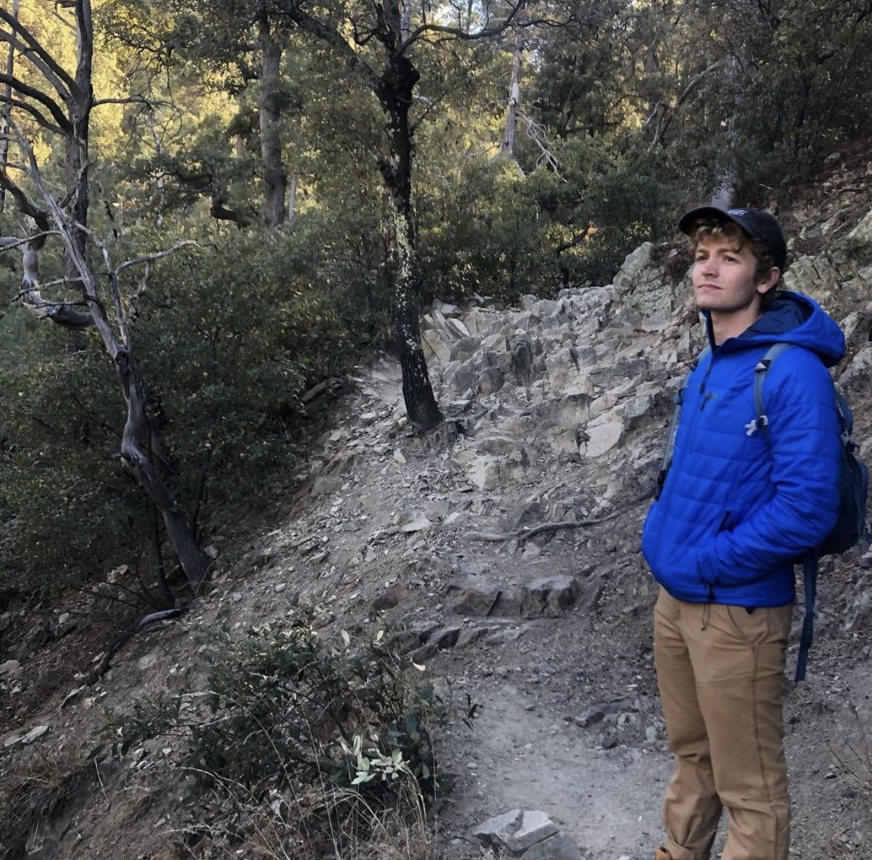 Nico Matthews standing on a shaded trail